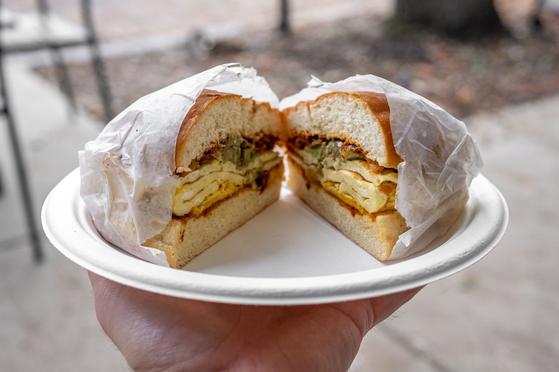 a pressed Cuban sandwich sliced in half on a plate in Tampa