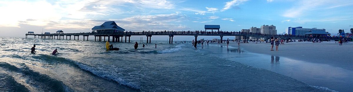 White sand and turquoise water at Clearwater Beach with beachgoers along the shore