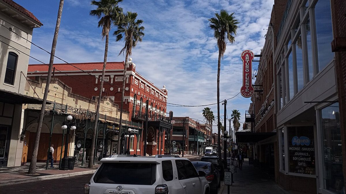 Historic brick storefronts and wrought-iron balconies along 7th Avenue in Ybor City